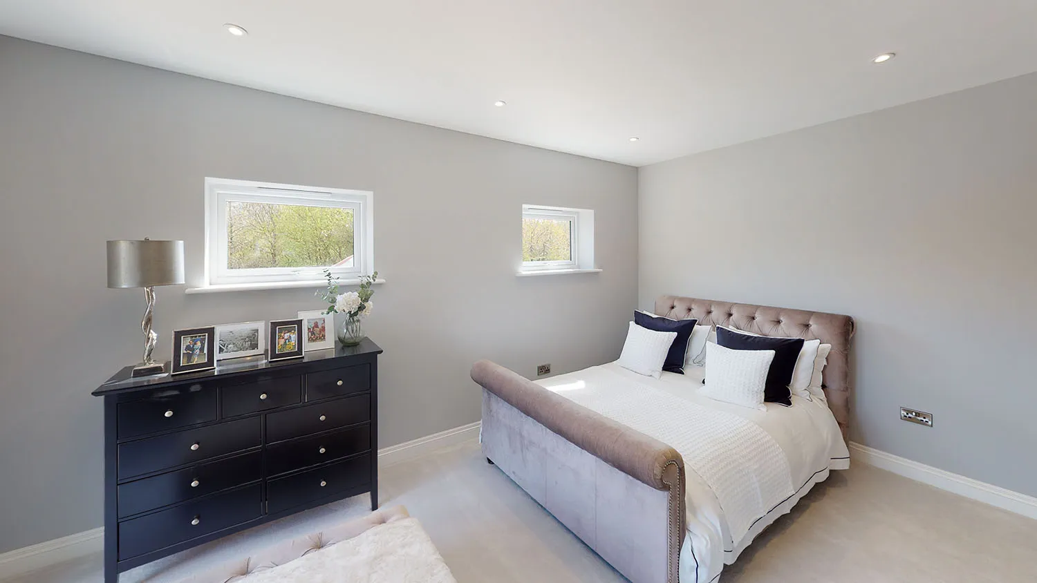a bedroom with a large bed and a dresser