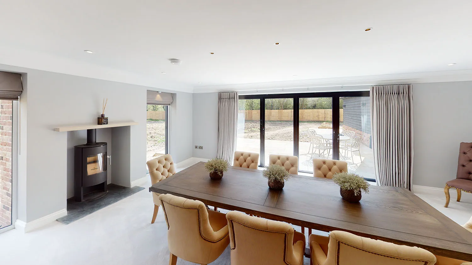 a dining room with a table and chairs and a fire place