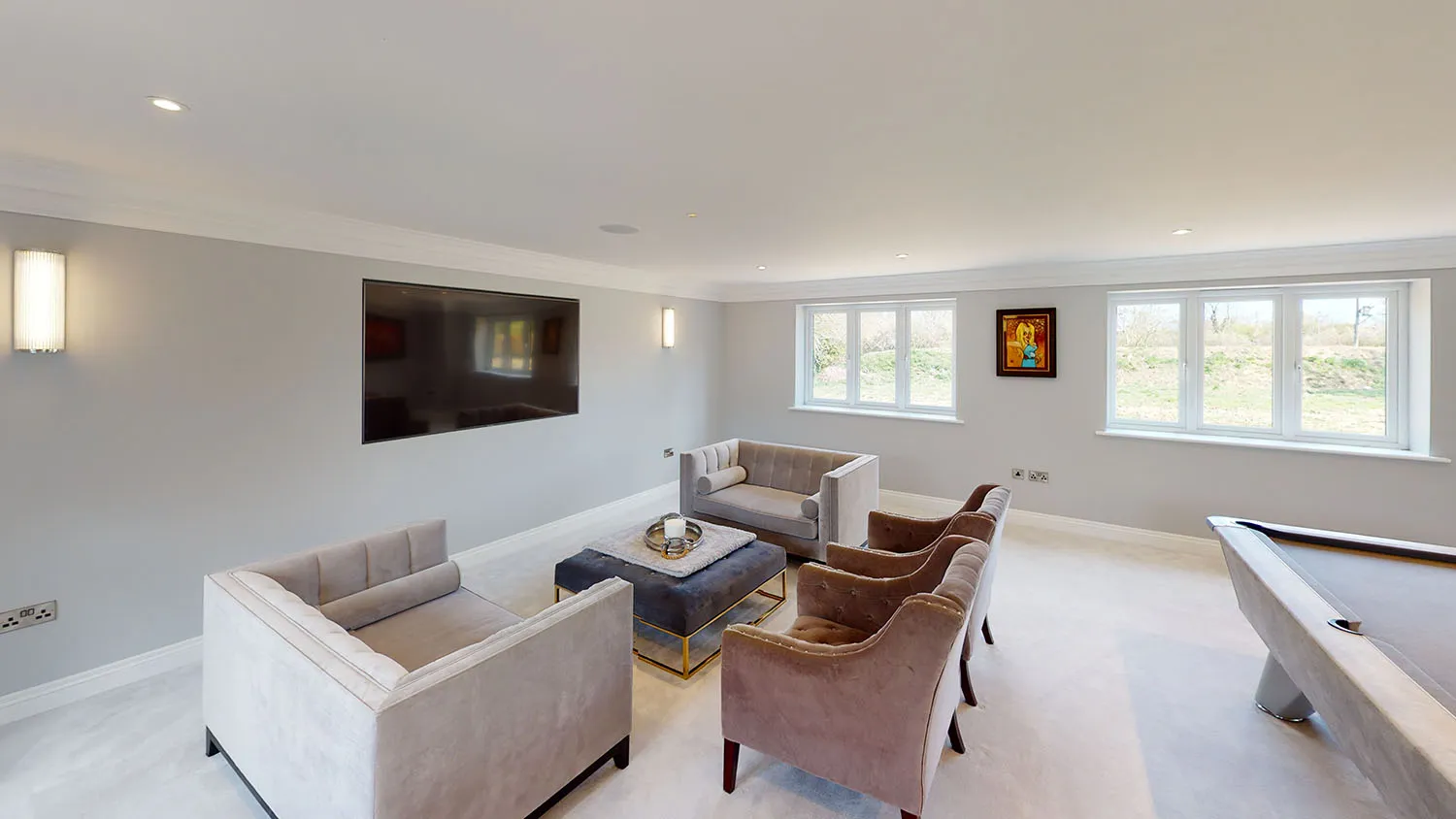 a living room filled with furniture and a pool table